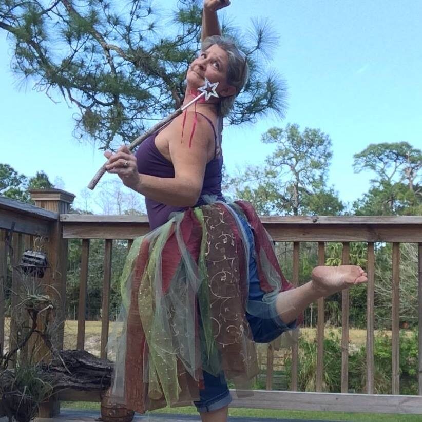 A woman in a hula skirt dancing on the deck